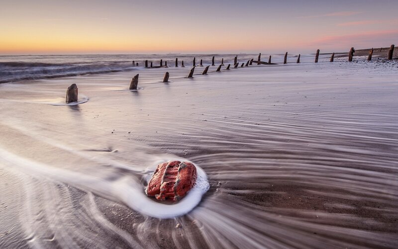 Red Rock on Beach — Brown