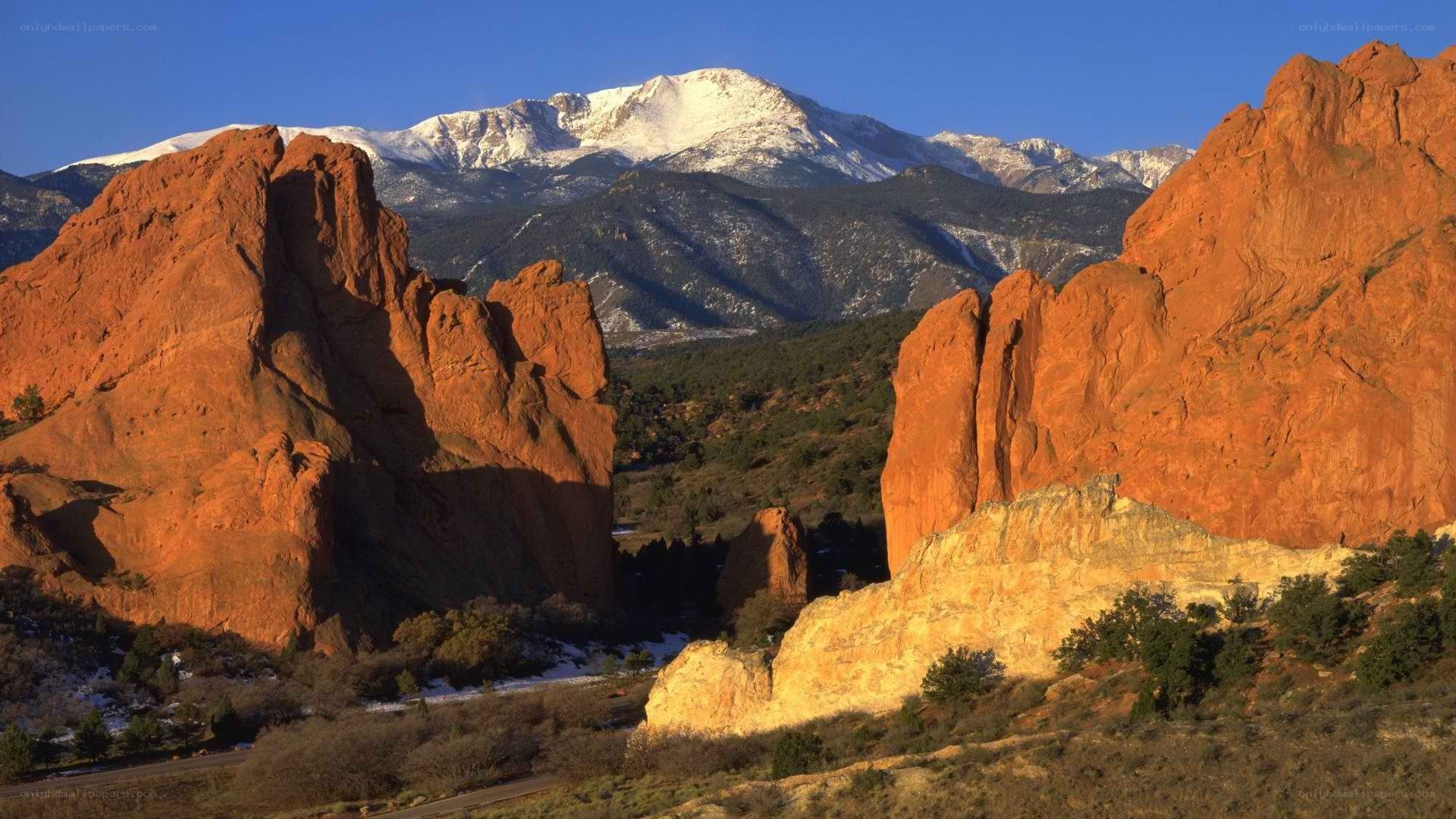 Red rocks with snow-capped mountains