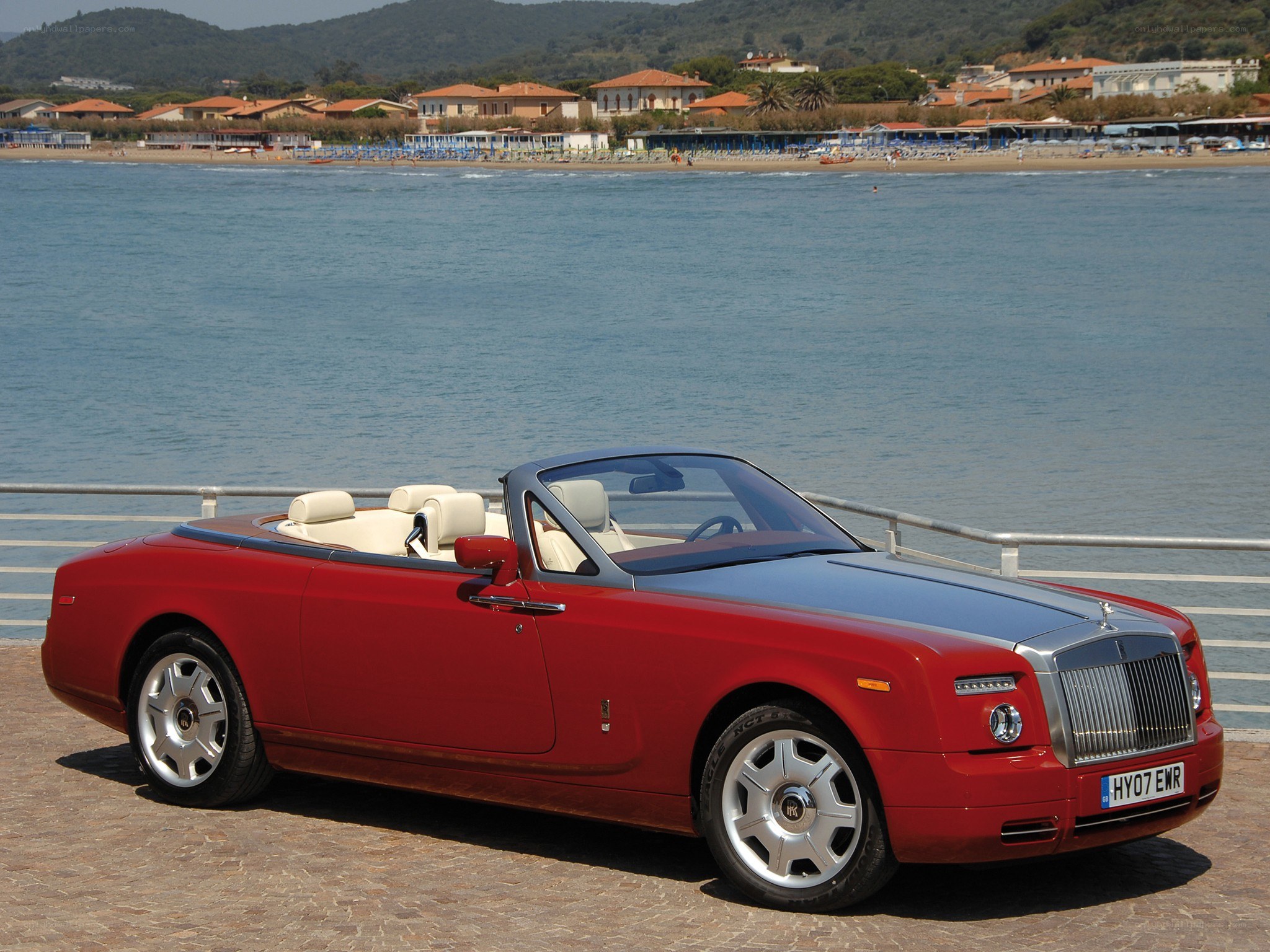 Red Rolls-Royce convertible by the sea
