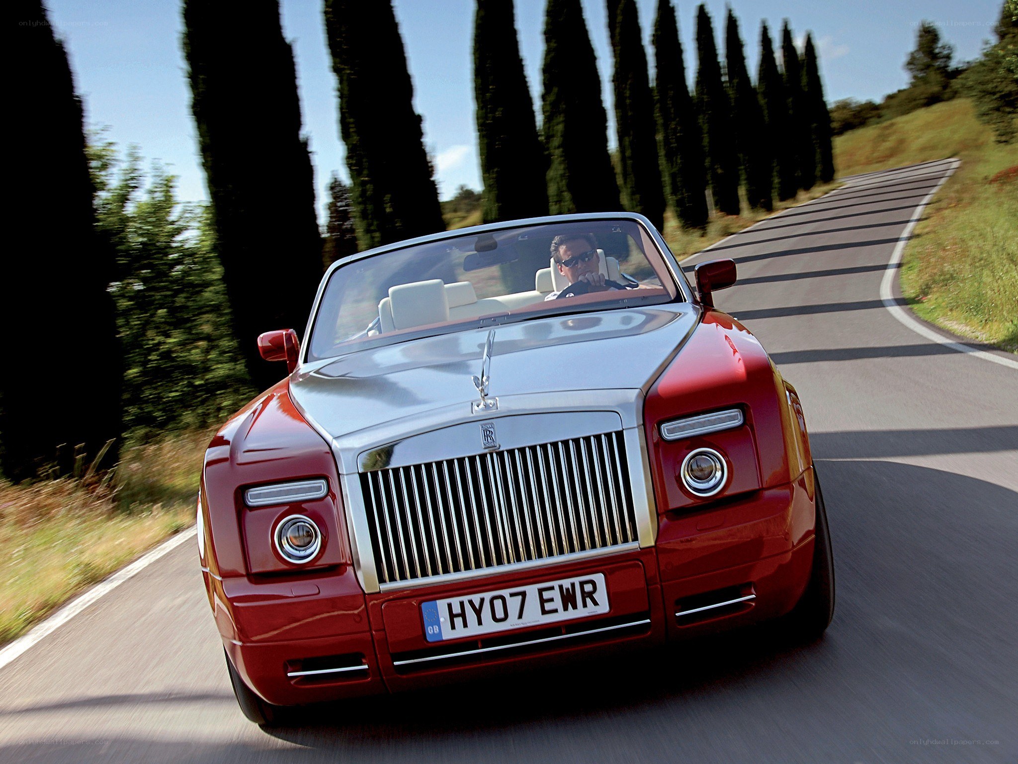 Red Rolls-Royce convertible on road