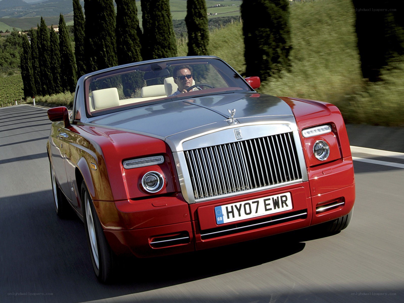 Red Rolls-Royce convertible on road