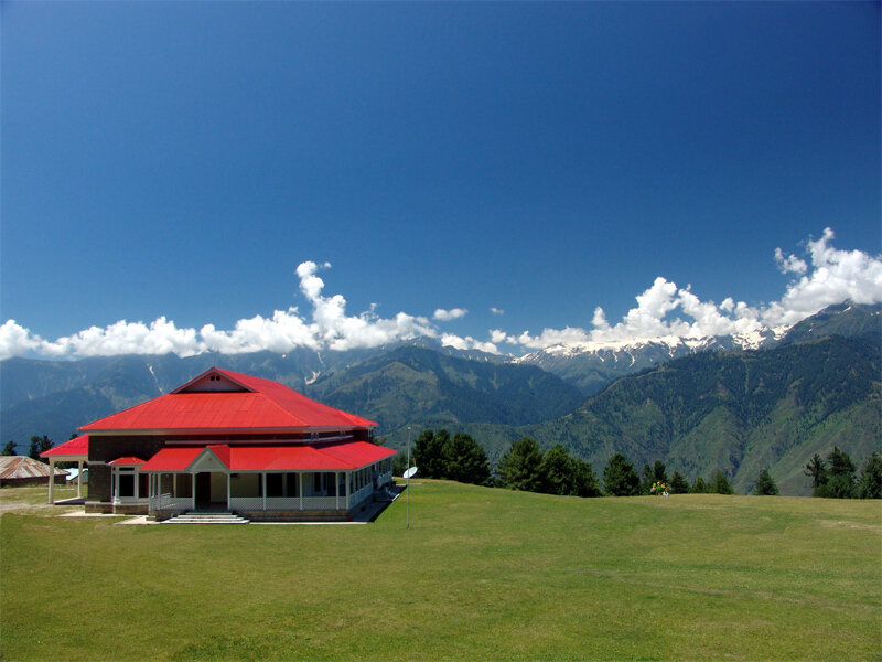 Red-roofed building in mountain valley
