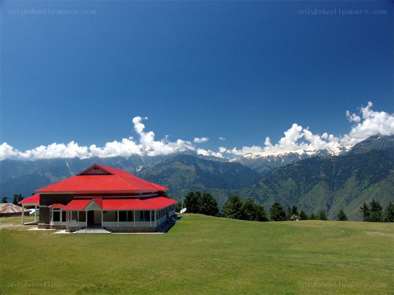 Red-roofed building in mountain valley