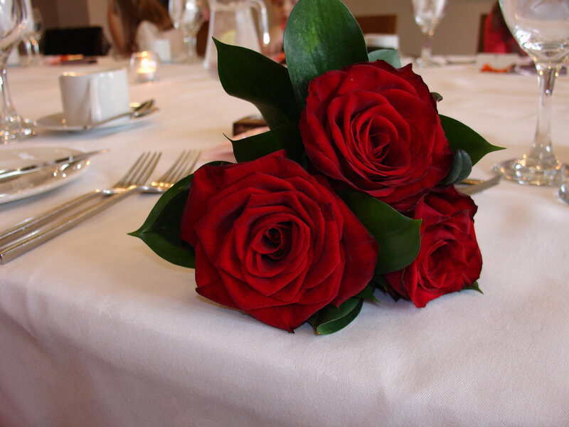 Red roses on a table setting