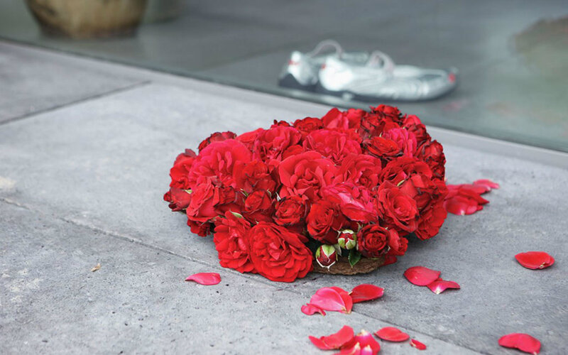 Red Roses on Pavement — Somber, Photograph