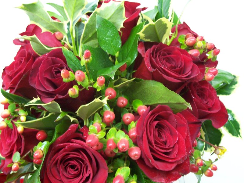 red roses with berries bouquet