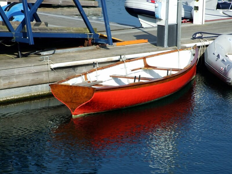 Red rowboat at a dock