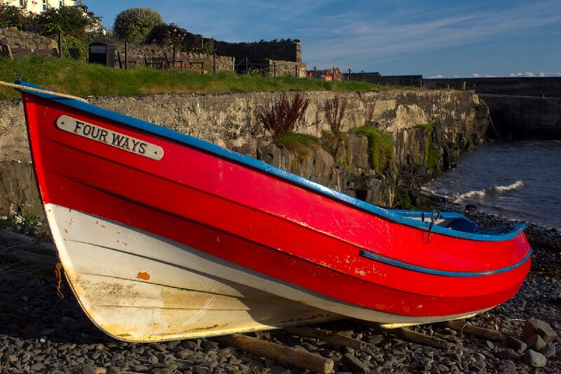 Red Rowboat on Shore