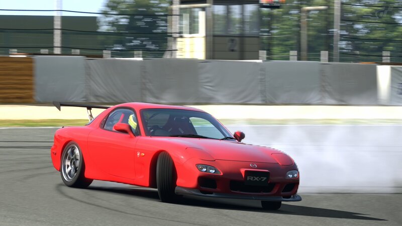 Red RX-7 drifting on track