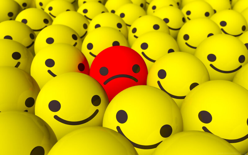 Red Sad Face Among Yellow