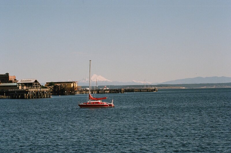 Red sailboat on calm water