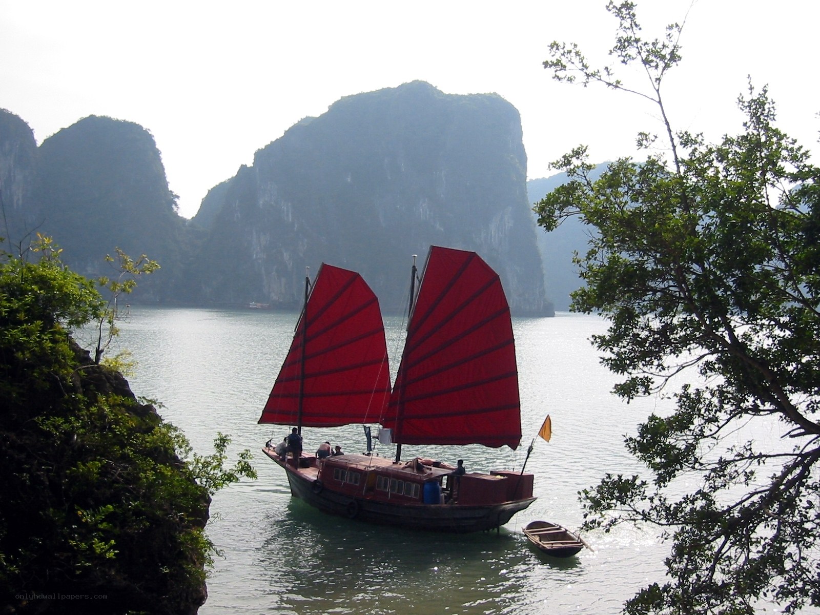 Red-sailed boat in a bay