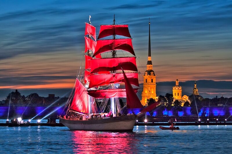 Red-sailed ship at dusk