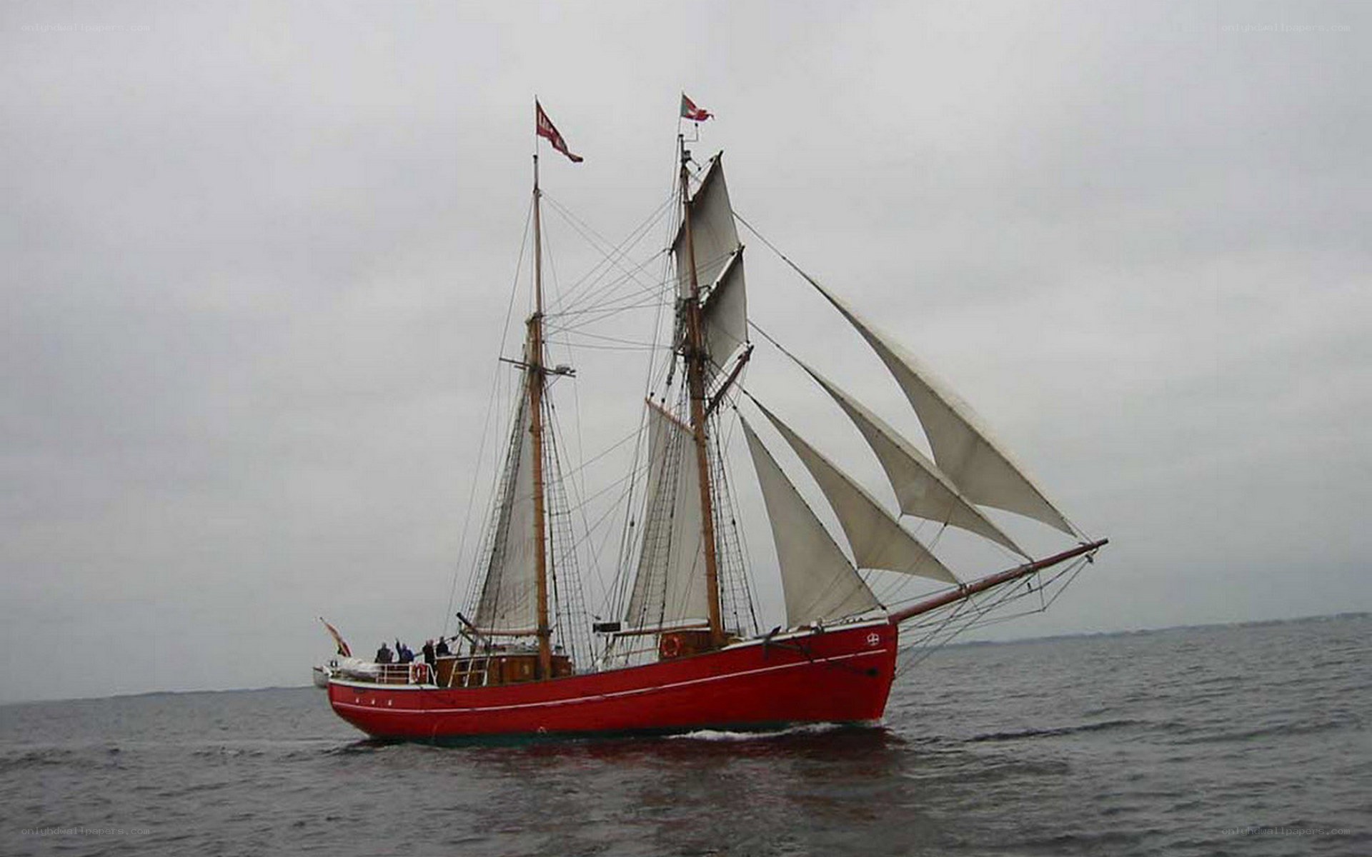 Red sailing ship on the water