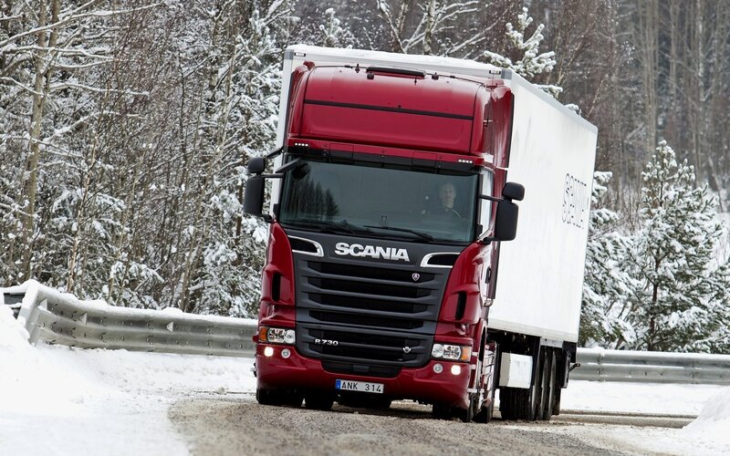 Red Scania truck on snowy road