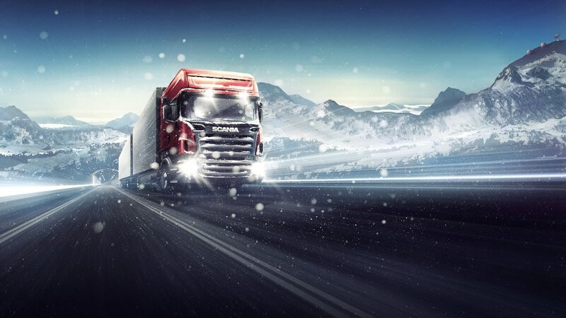 Red Scania truck on snowy road