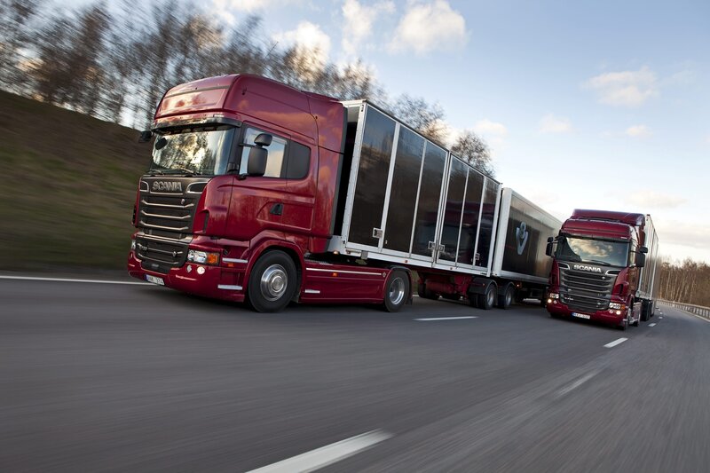 Red Scania trucks on highway
