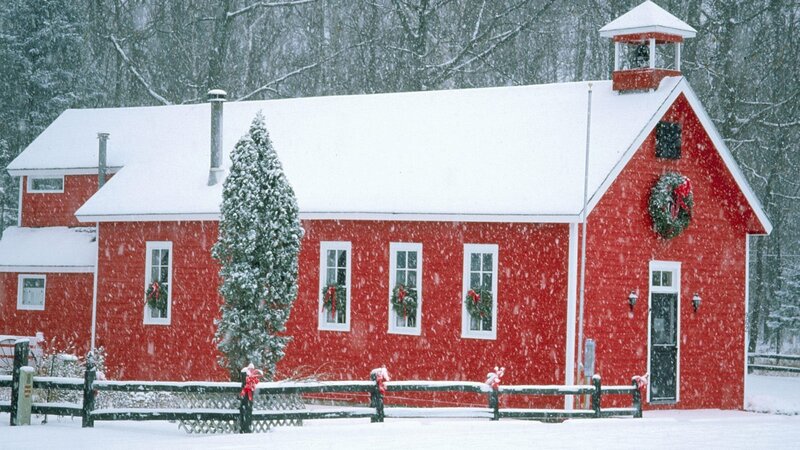 Red schoolhouse in snow
