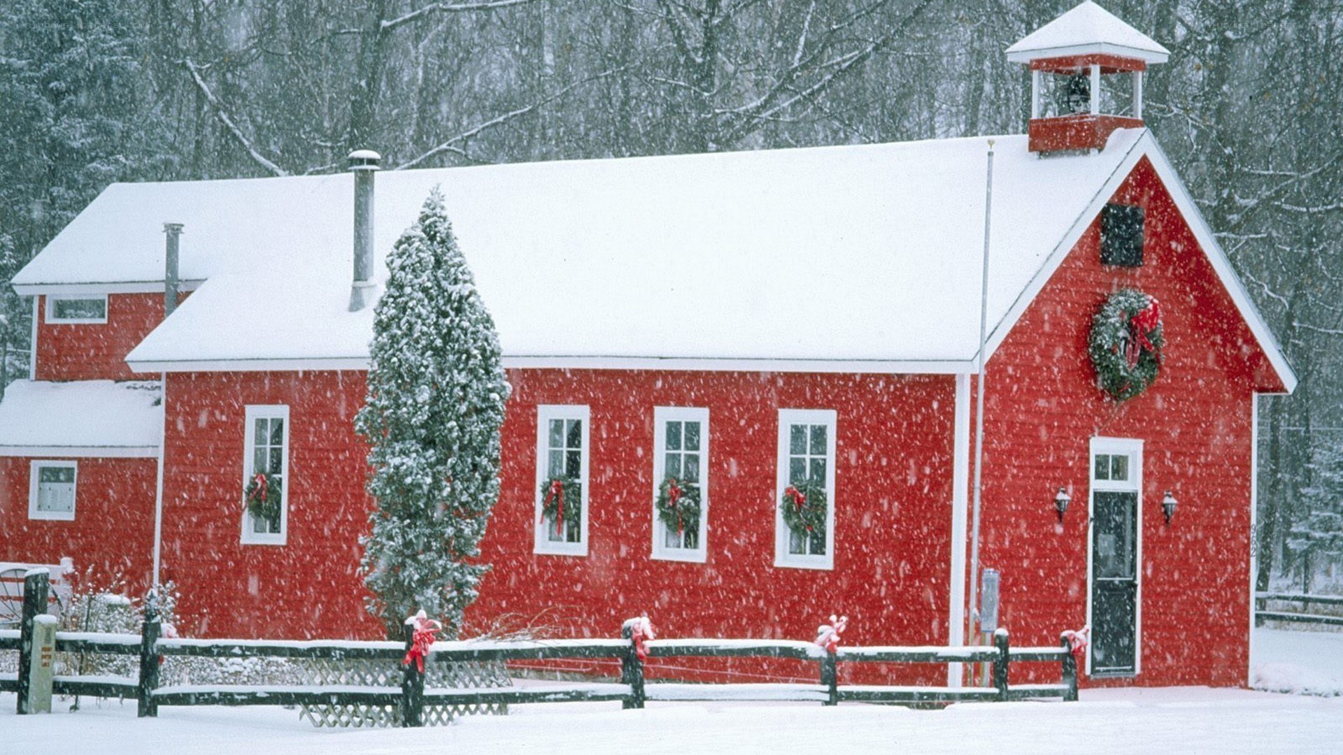 Red schoolhouse in snow