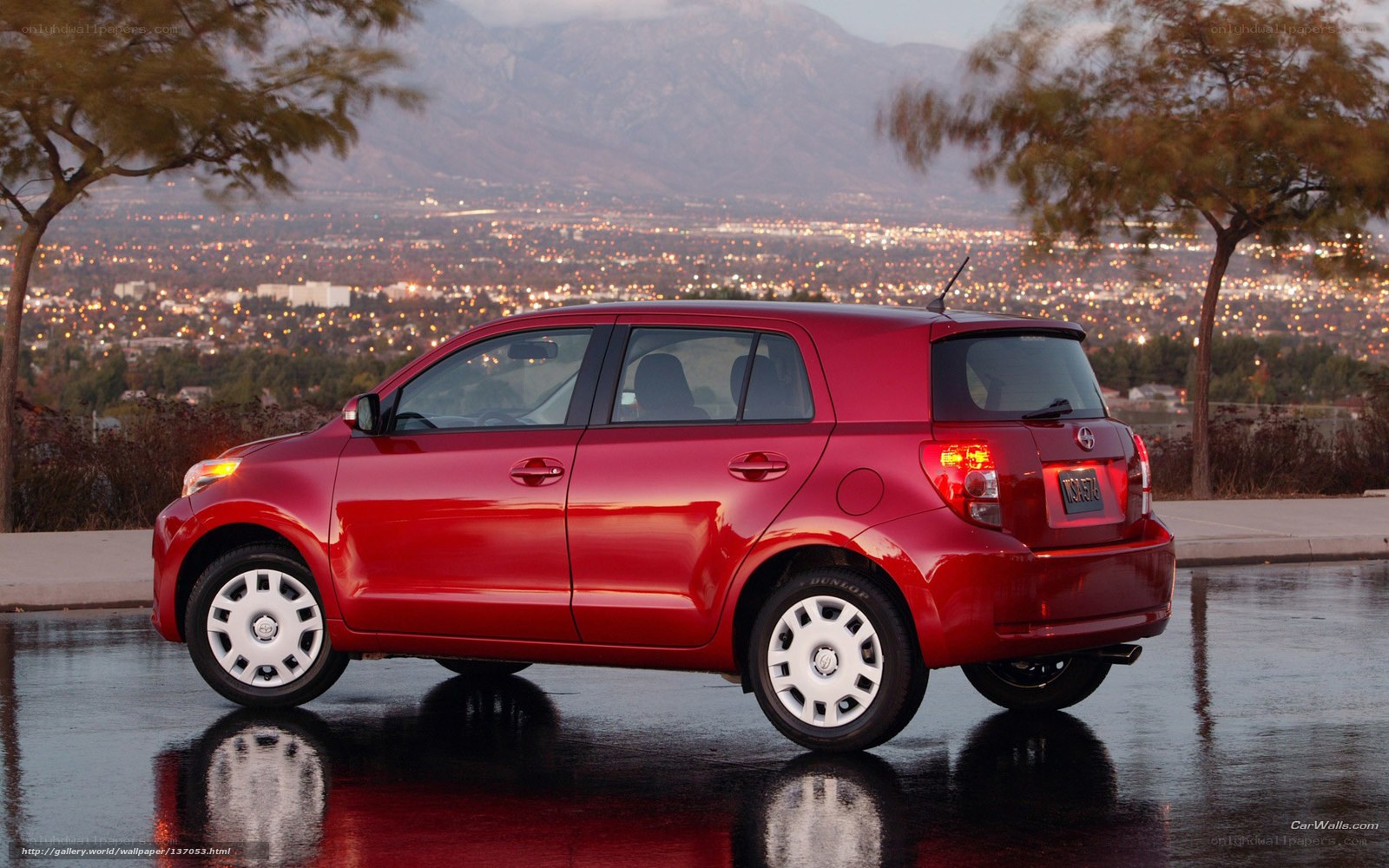 Red Scion xD parked at dusk