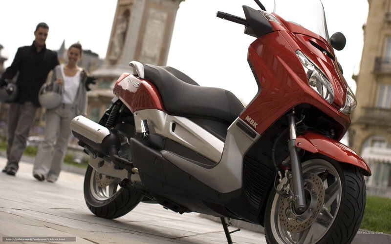 Red scooter in city square