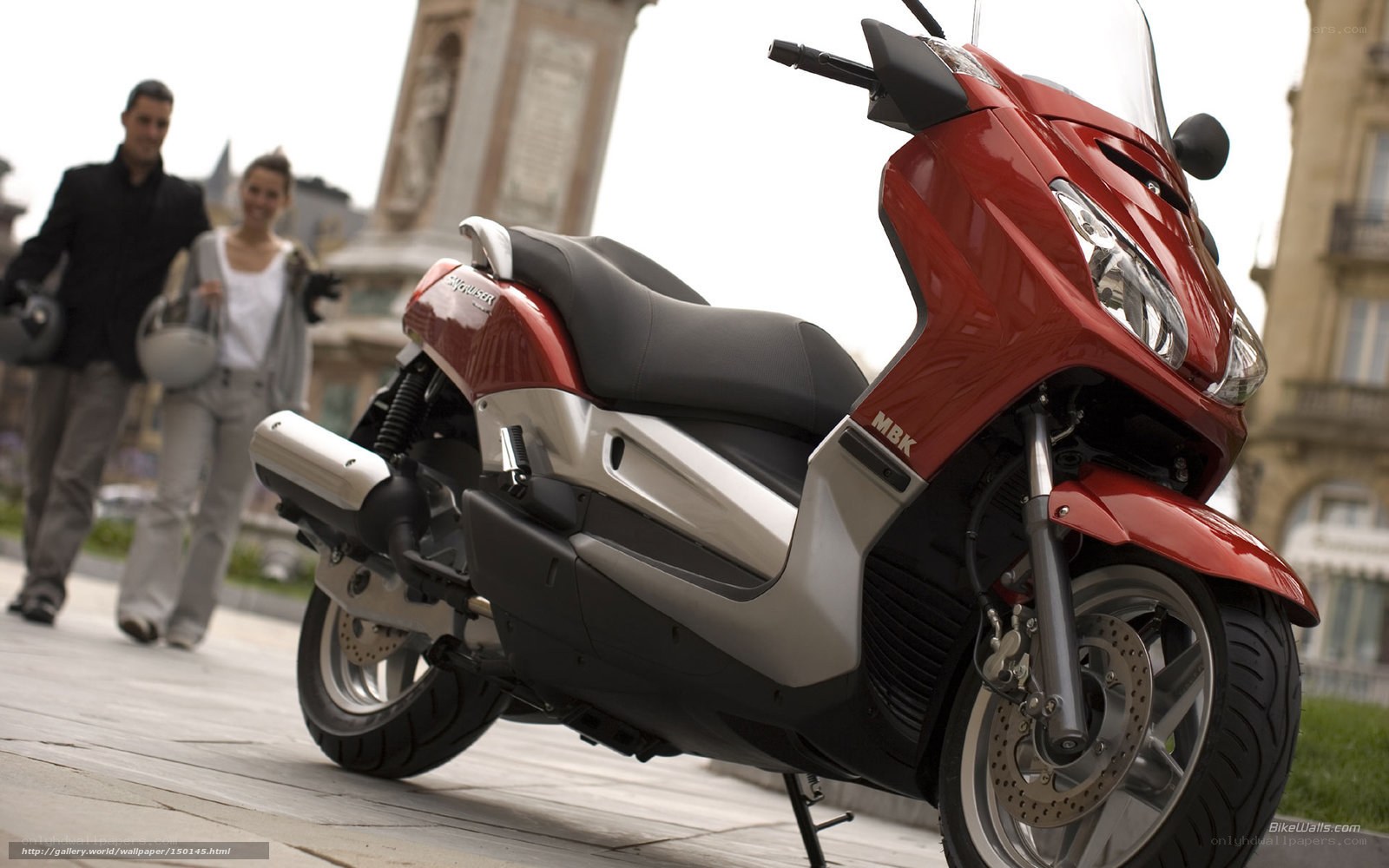 Red scooter in city square