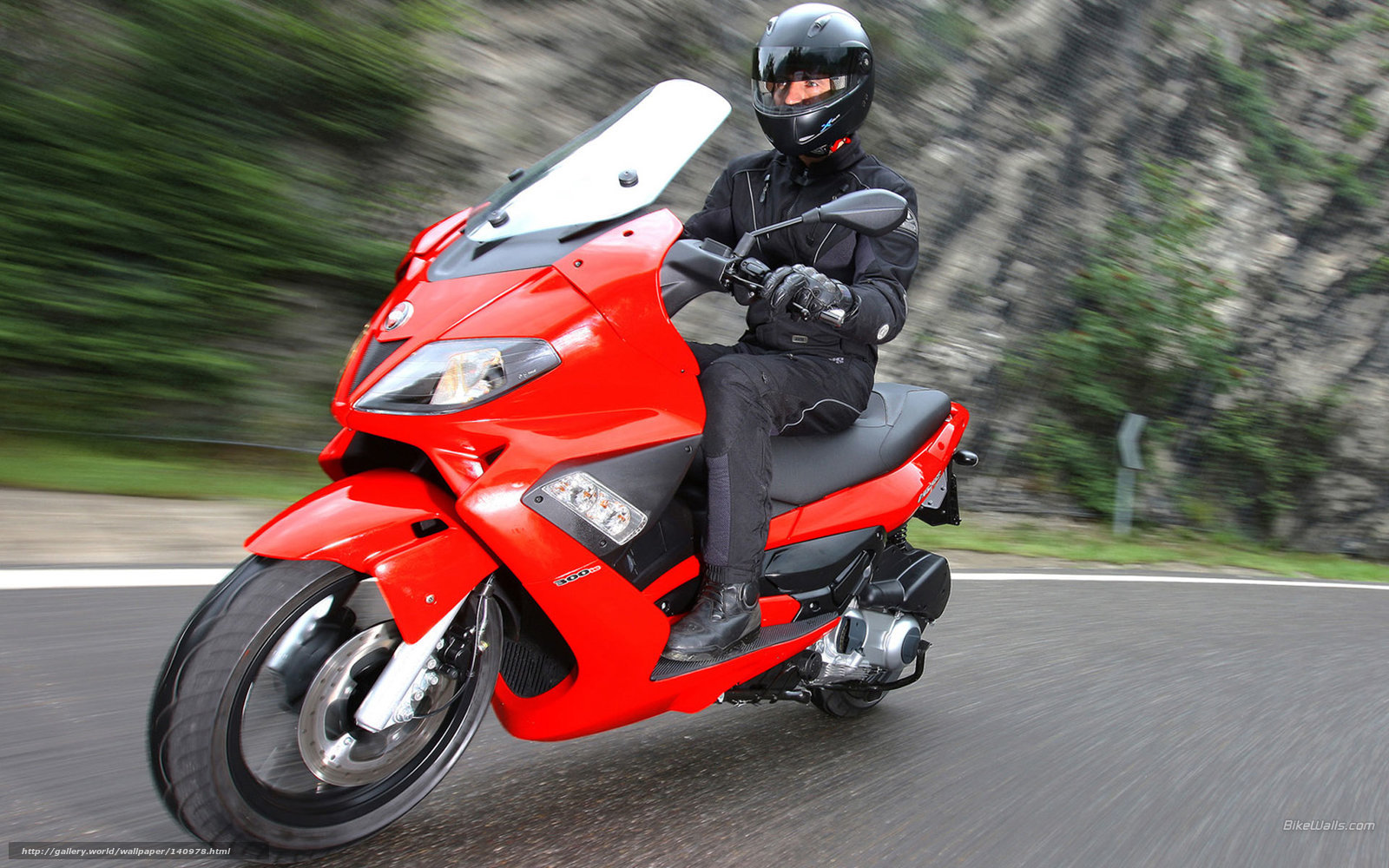 Red scooter on a winding road