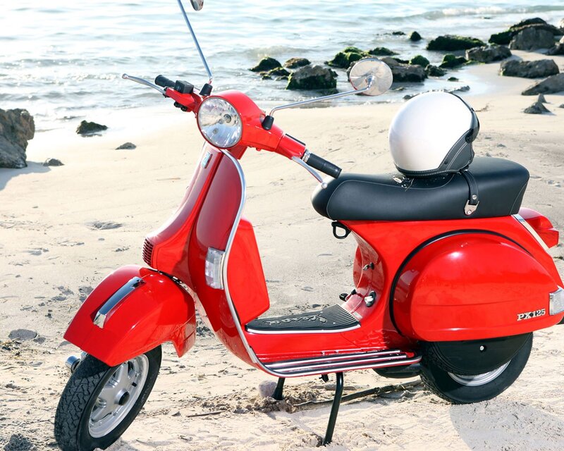 Red scooter on beach