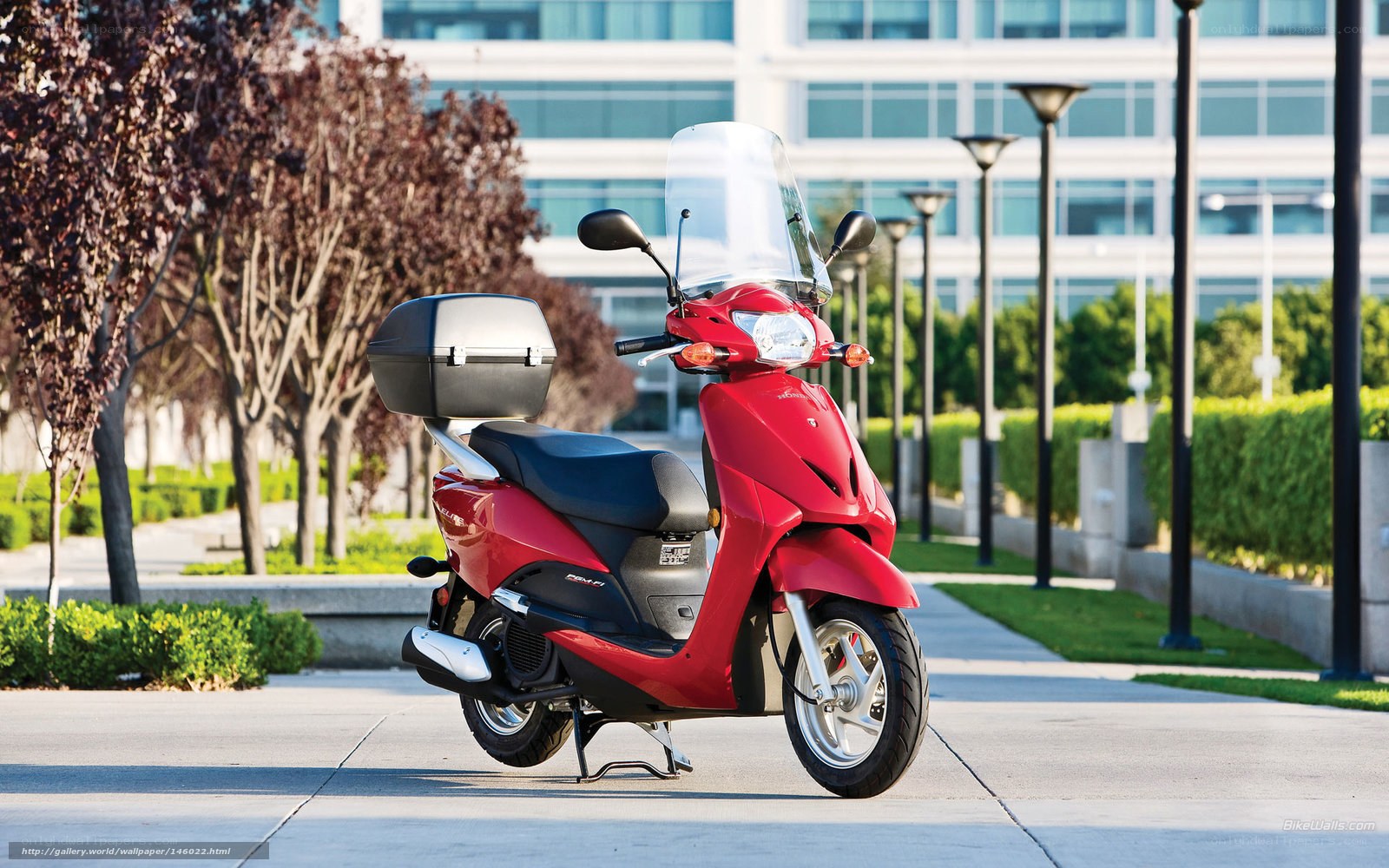 Red scooter on city sidewalk