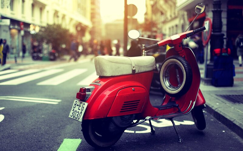 Red scooter on city street