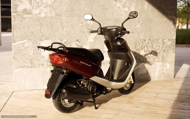 Red scooter parked against wall