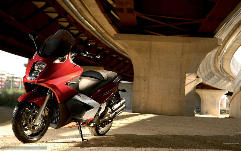 Red scooter under a bridge