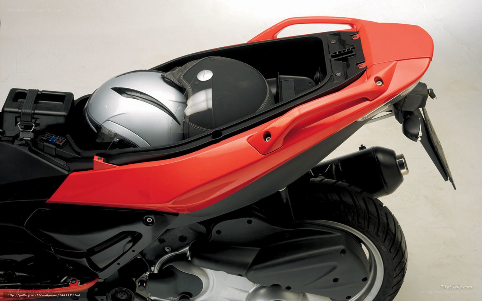 Red scooter with helmet storage