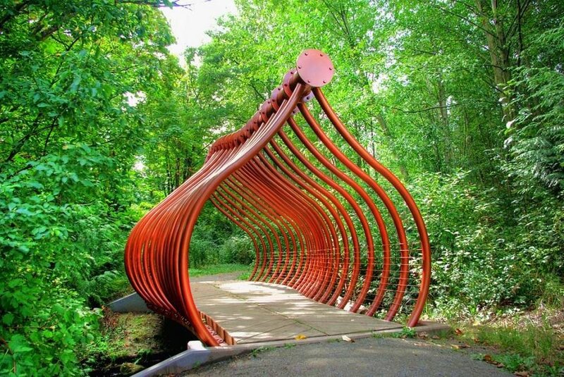 Red sculpture bridge in forest