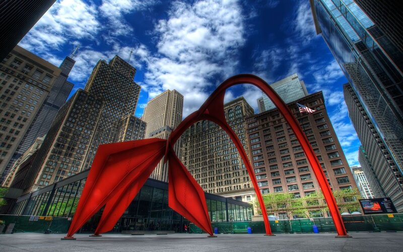 Red sculpture in city plaza