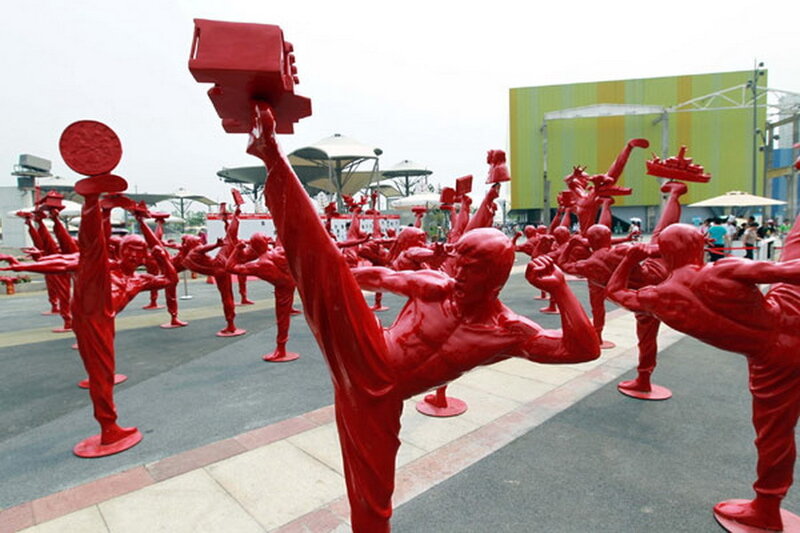 Red sculptures in martial arts poses