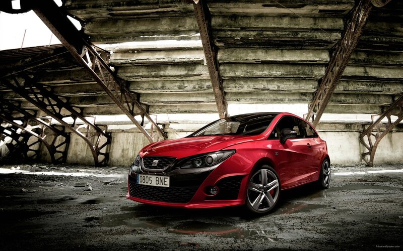 Red SEAT Leon in industrial setting