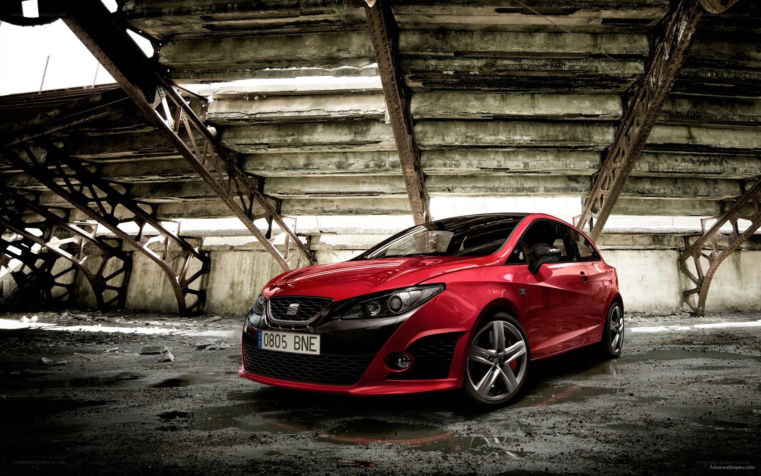 Red SEAT Leon in industrial setting