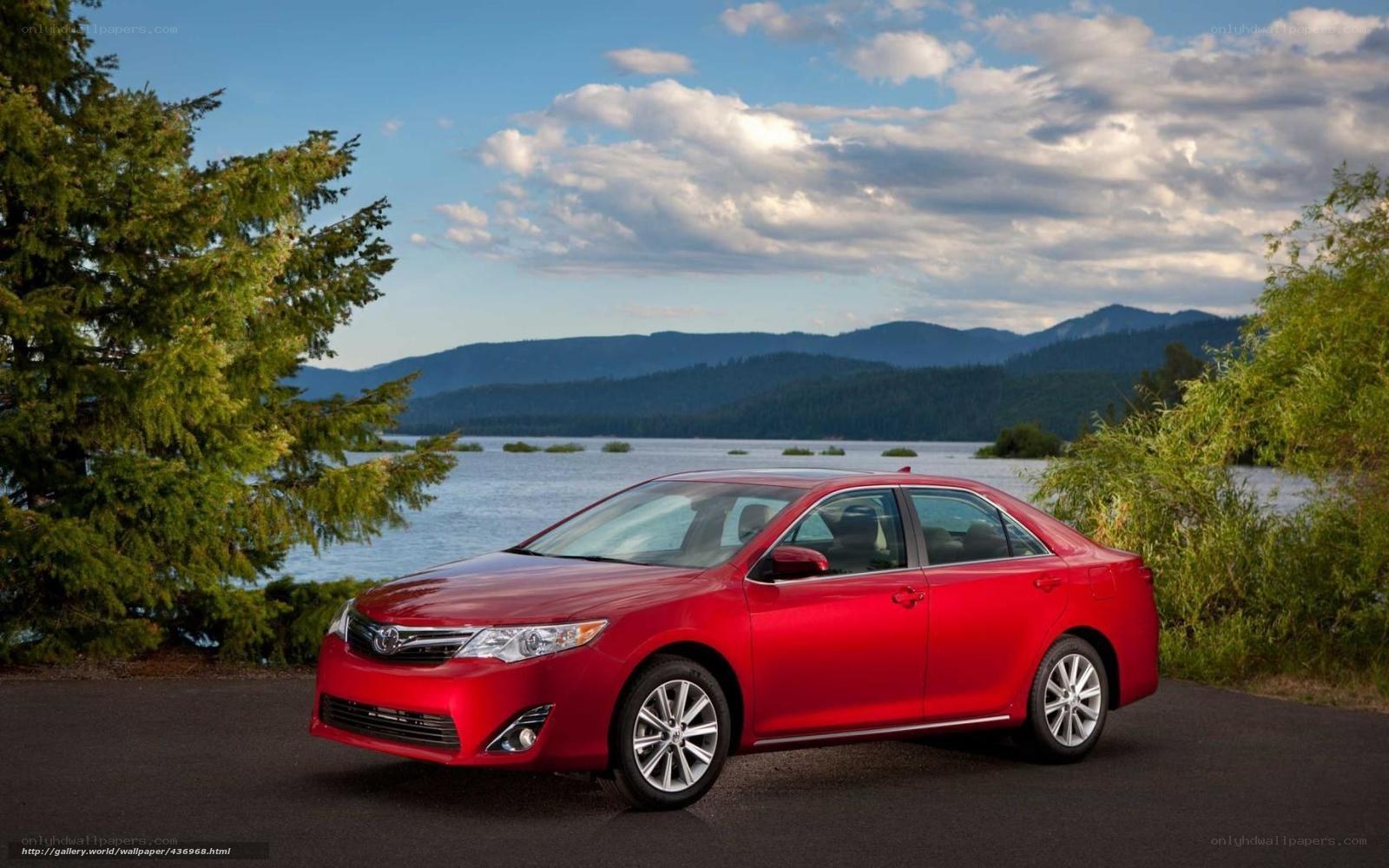 Red sedan by a lake