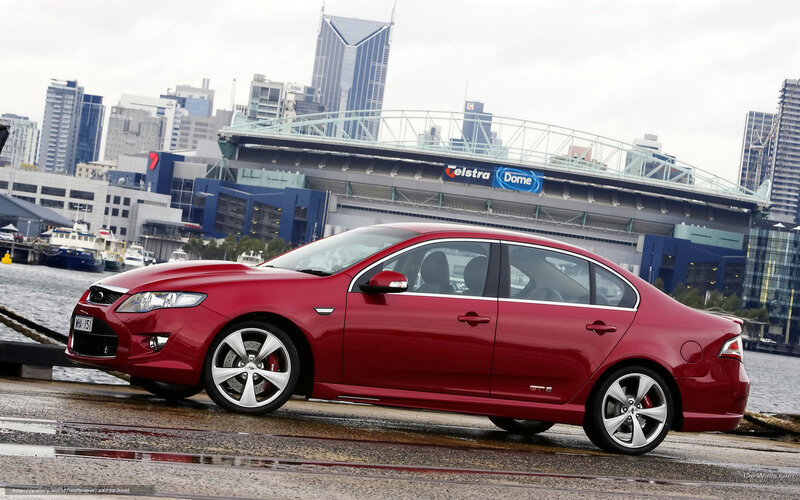Red sedan by the waterfront