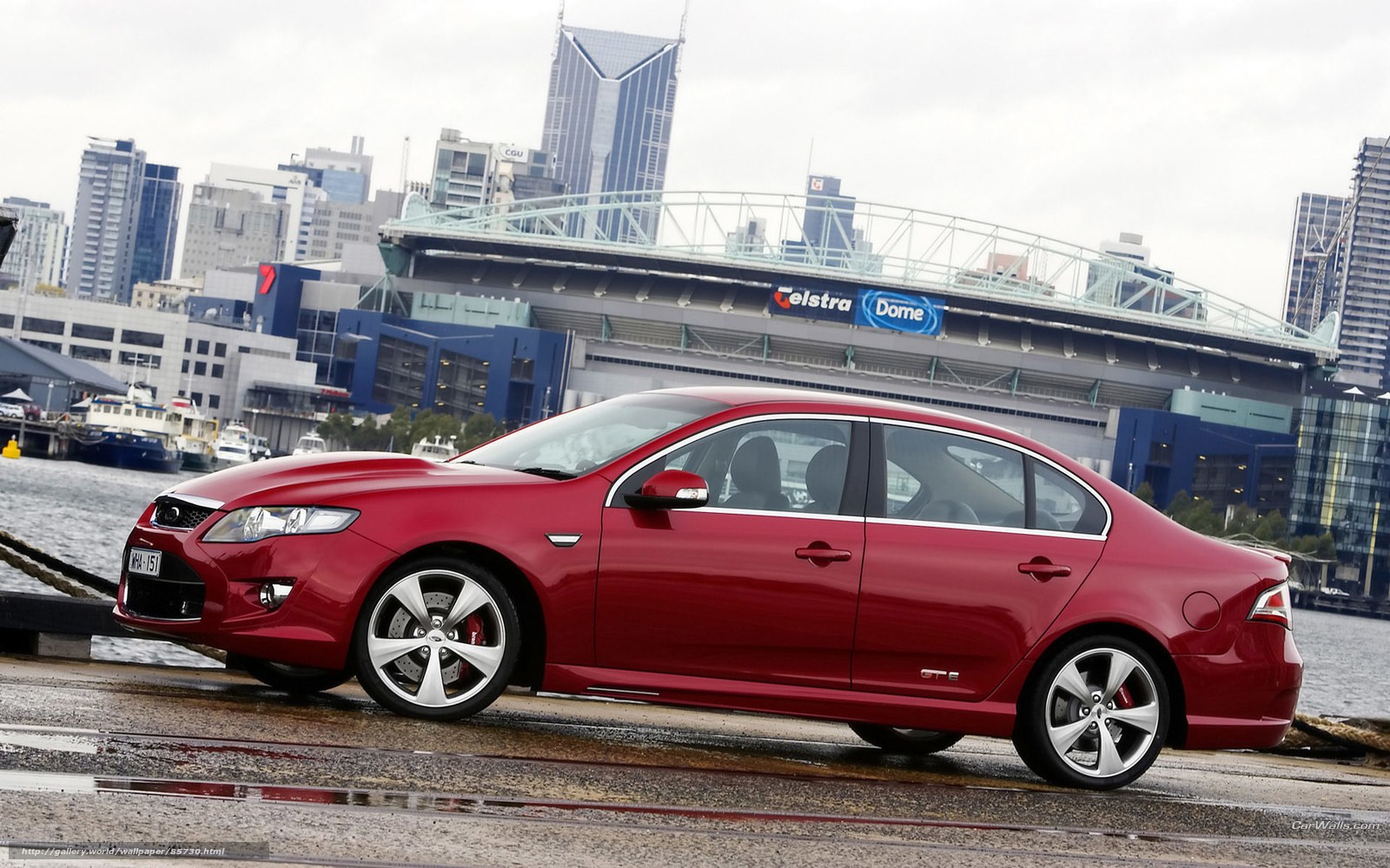 Red sedan by the waterfront