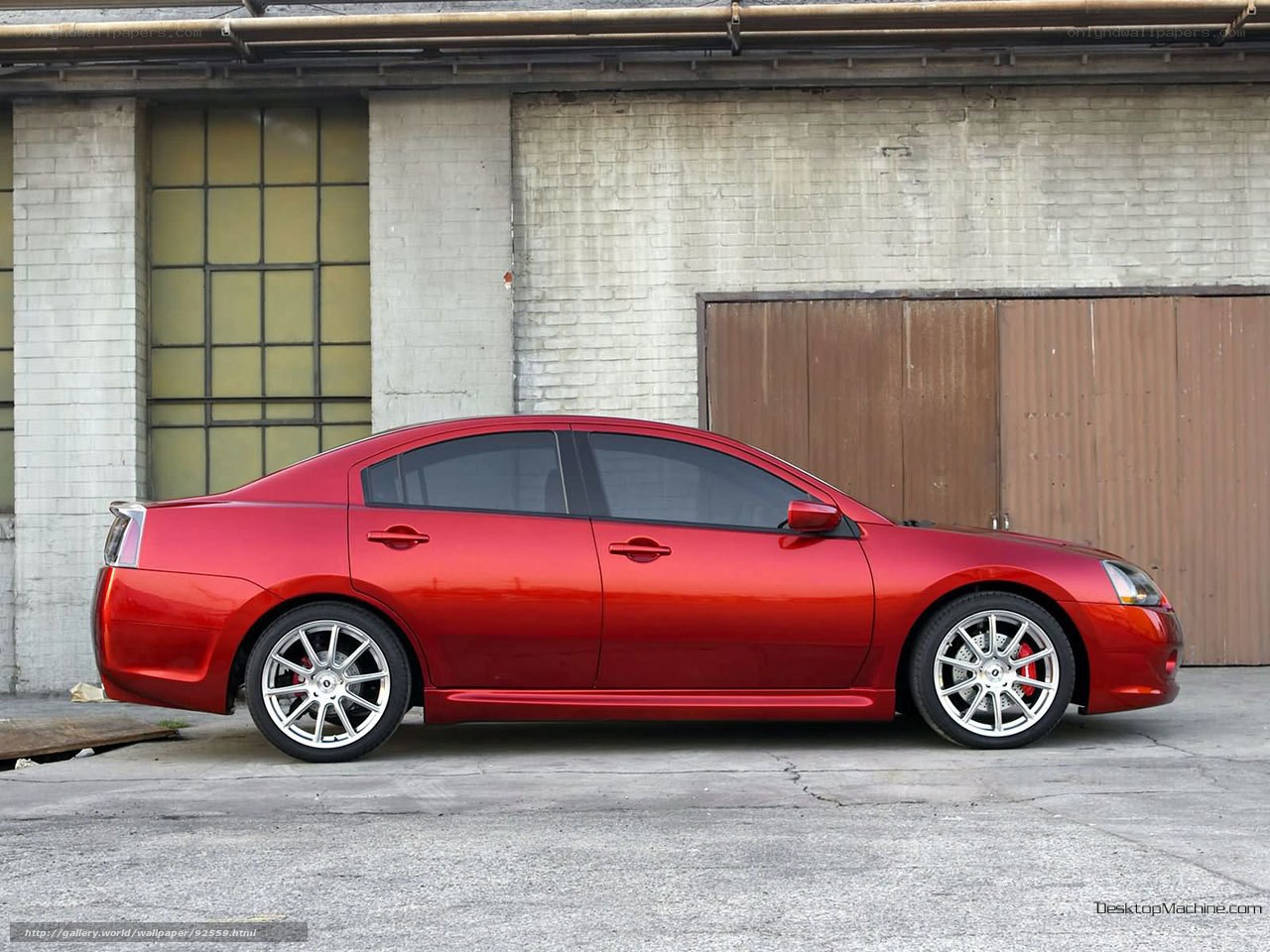 Red sedan car in industrial setting