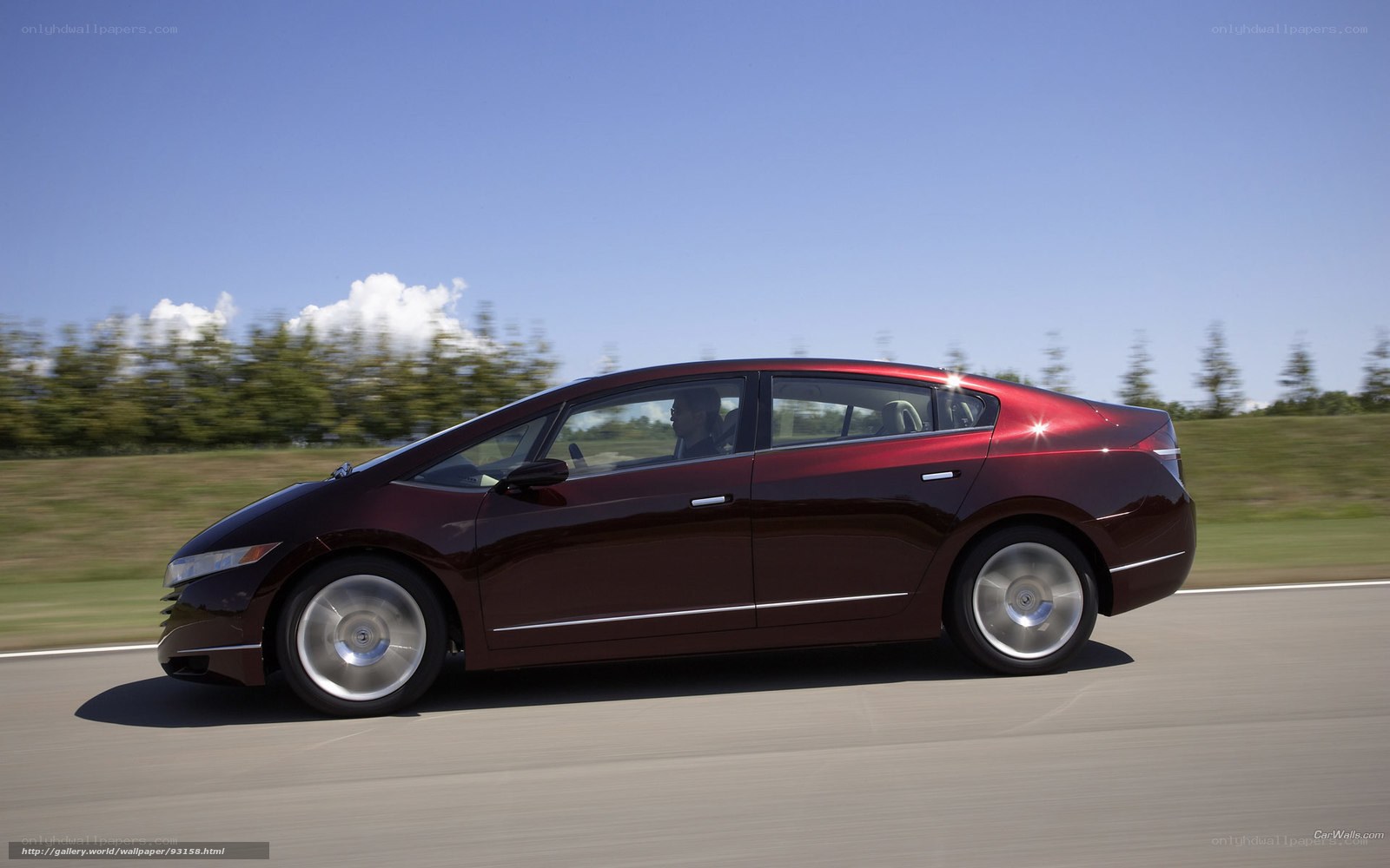 red sedan driving on road
