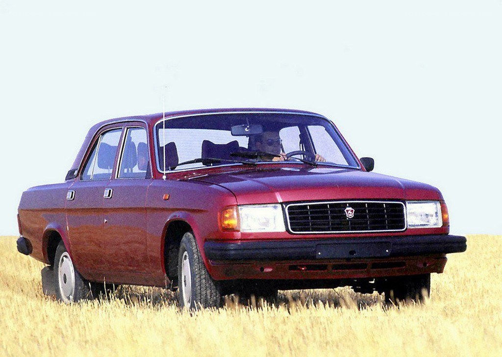 Red sedan in a field