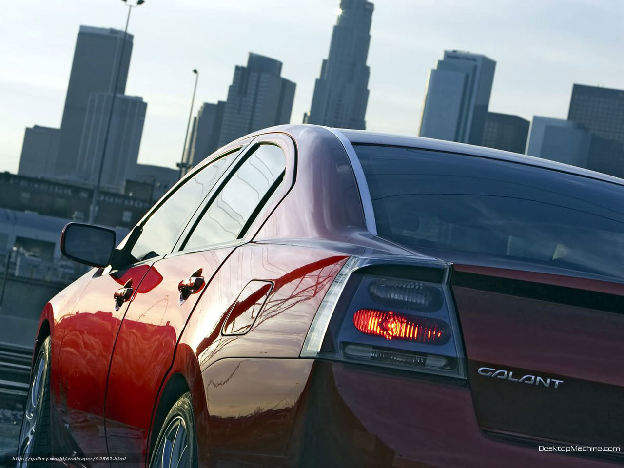 Red sedan in cityscape
