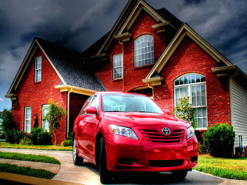 Red Sedan in Driveway