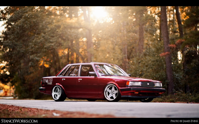 Red sedan in forest