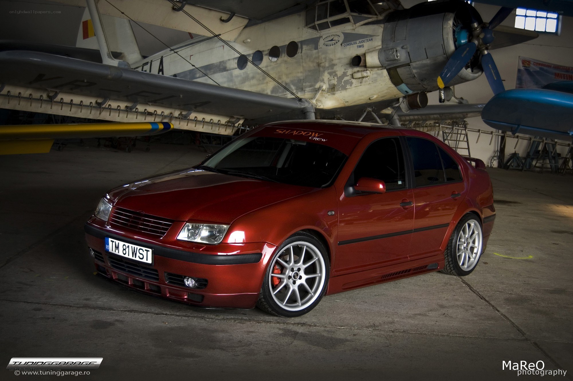 Red sedan in hangar
