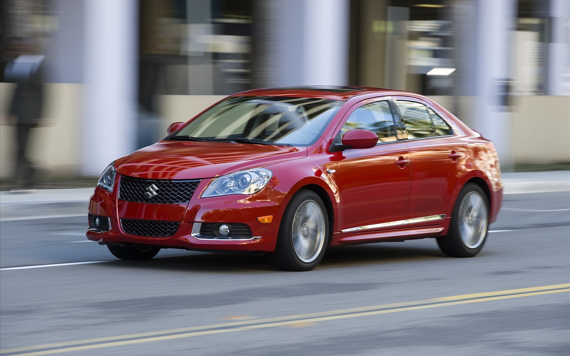 Red sedan in motion