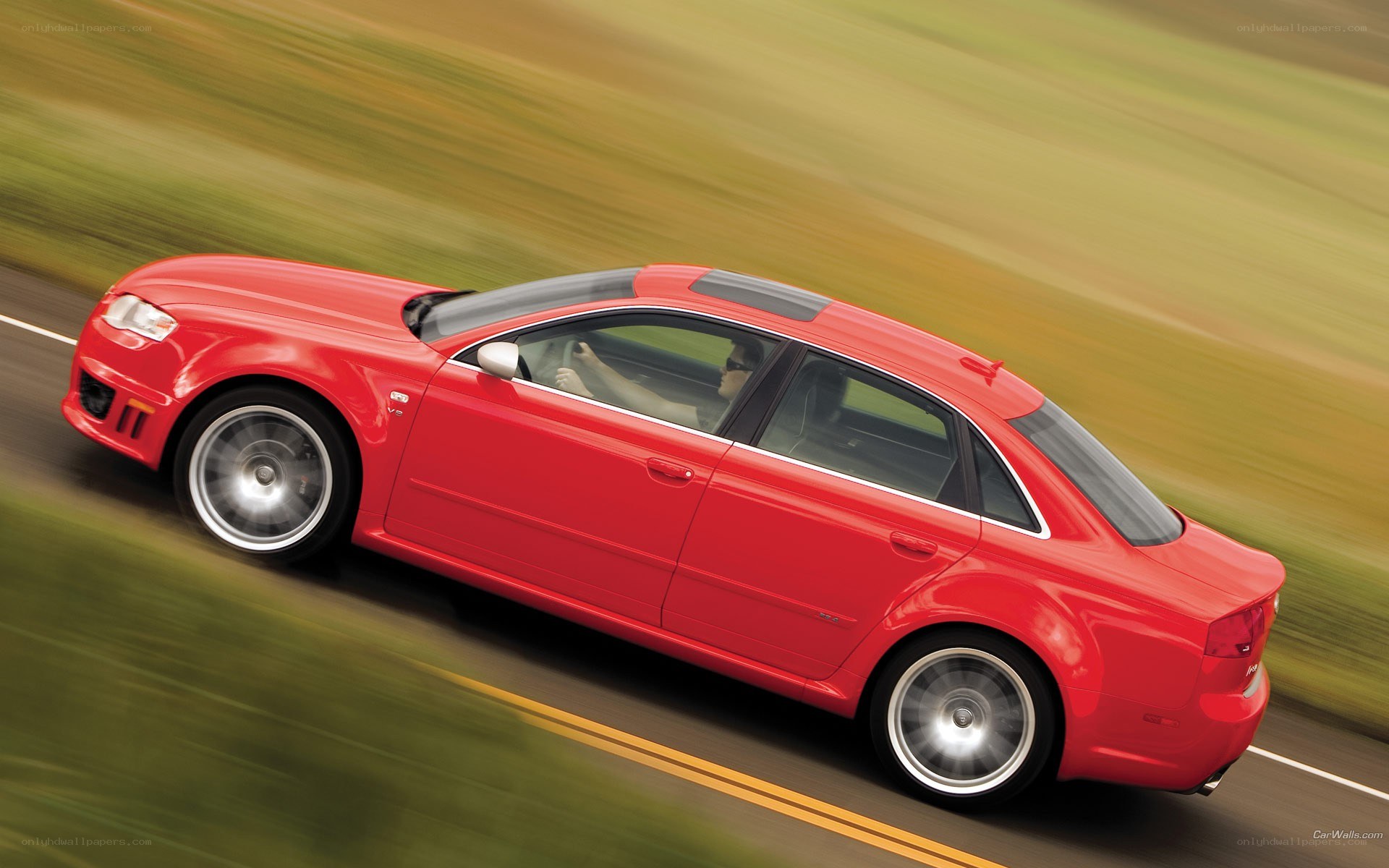 red sedan in motion